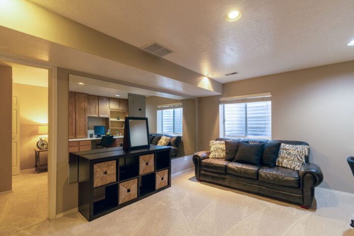 pexels-5661020 Warm and inviting basement living room featuring a leather sofa and modern decor.