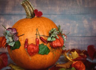 8 Easy DIY Fall Decor Projects to Make Your Home Feel Cozy A decorated pumpkin adorned with leaves and flowers, capturing the essence of autumn.