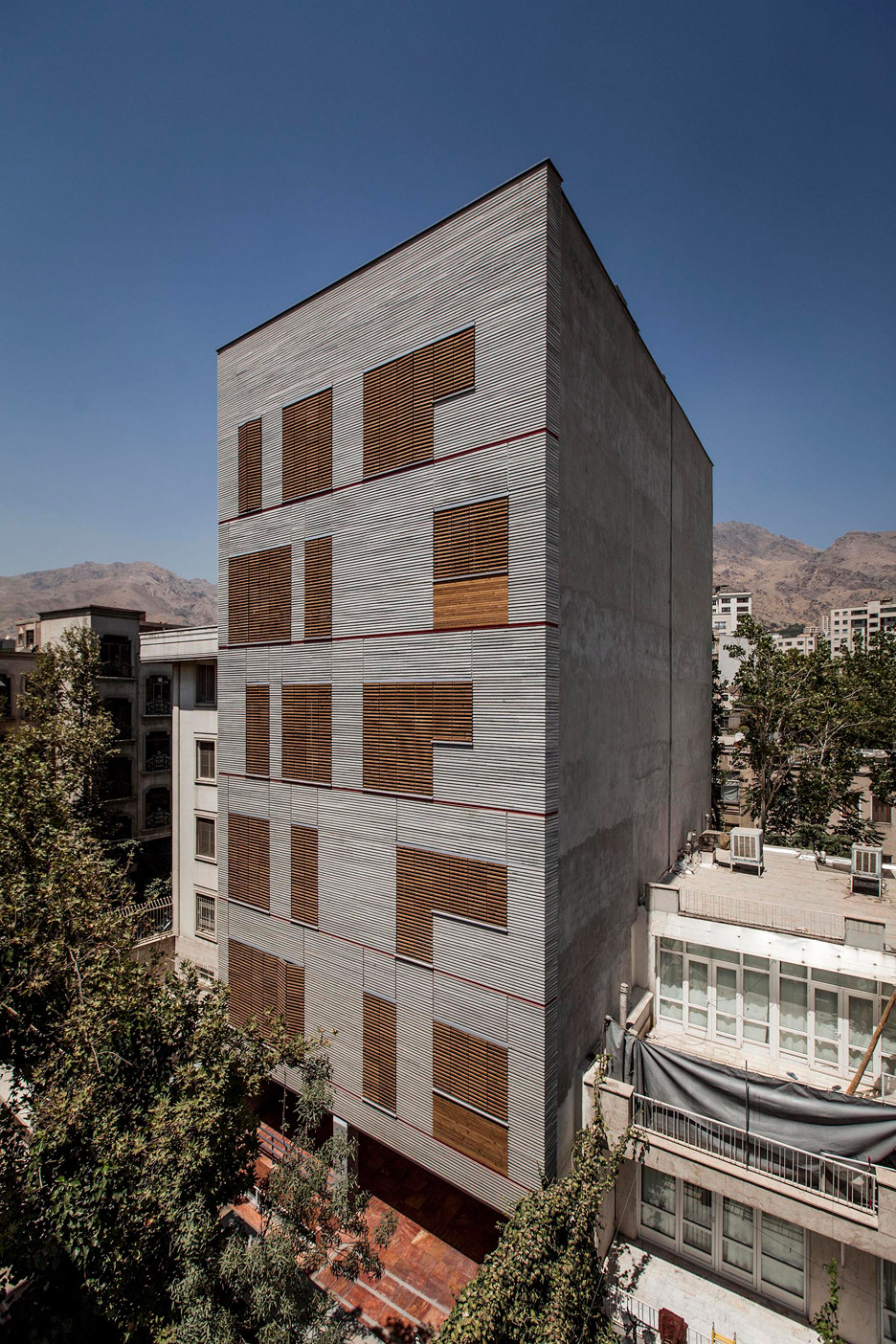 Ayeneh Office Gives Tehran Apartments A Textured Facade With Ridged Granite And Slatted Timber