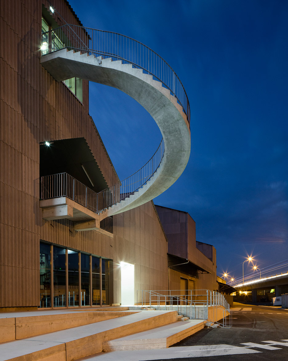 Curving Concrete Staircase Protrudes From Warehouse-like Circus School In France