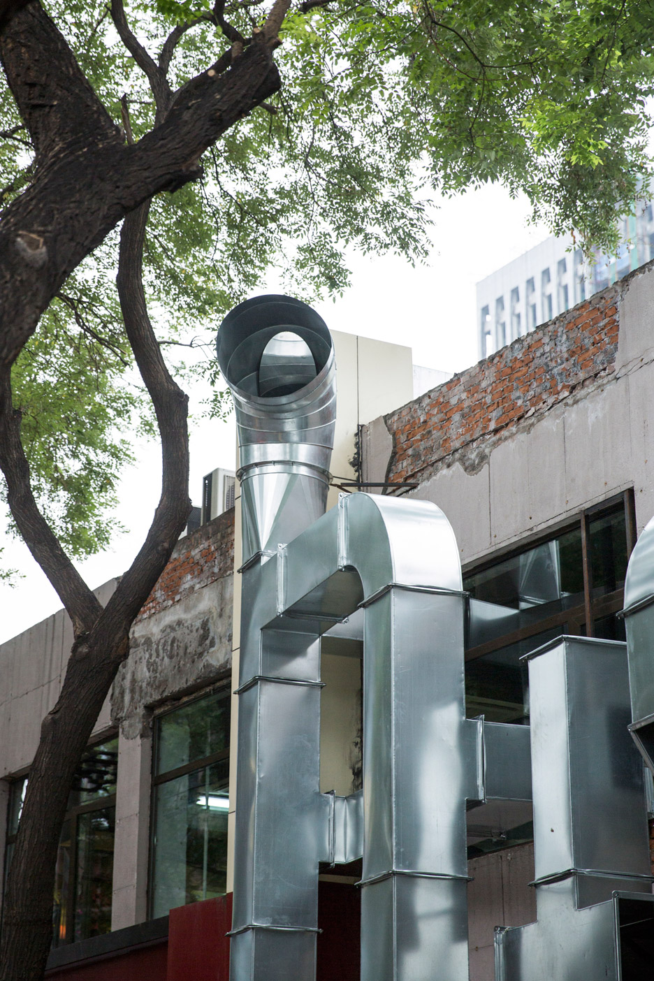 People’s Architecture Office Uses Ventilation Pipes To Create Typographic Installation