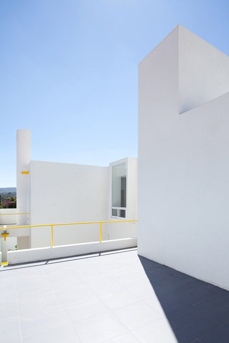 Yellow Accents Brighten The Stacked White Volumes Of Pino Street House By Oscar Gutiérrez