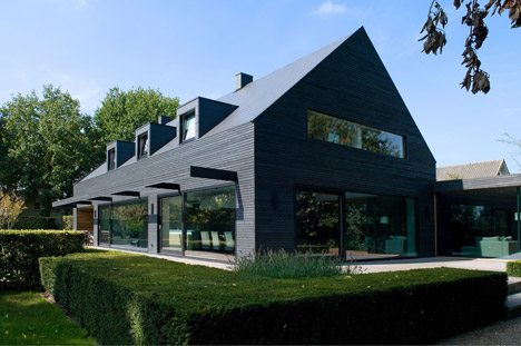 House In The Netherlands Upgraded With A Dark Grey Cladding Of Timber Panels And Tiles