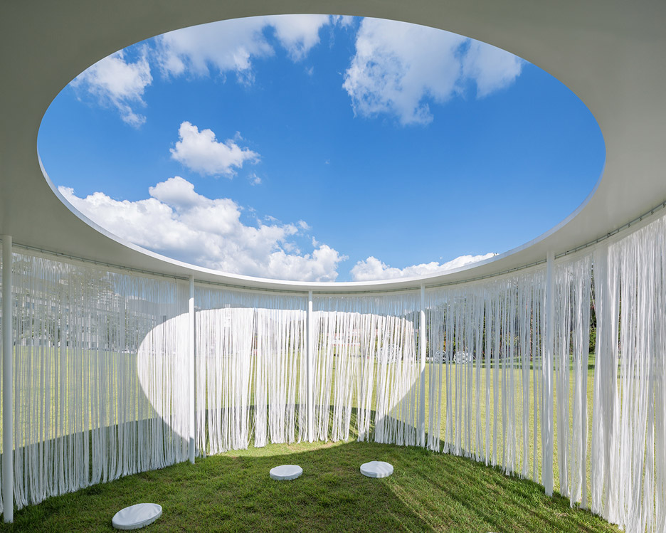 Translucent Curtains Surround “floating” Oasis Pavilion By OBBA