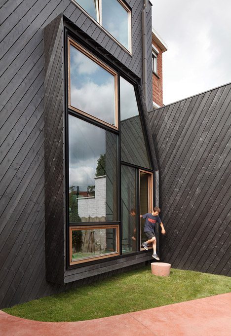 Assorted Windows And Diagonal Cladding Feature On Renovated Home By NU Architectuuratelier